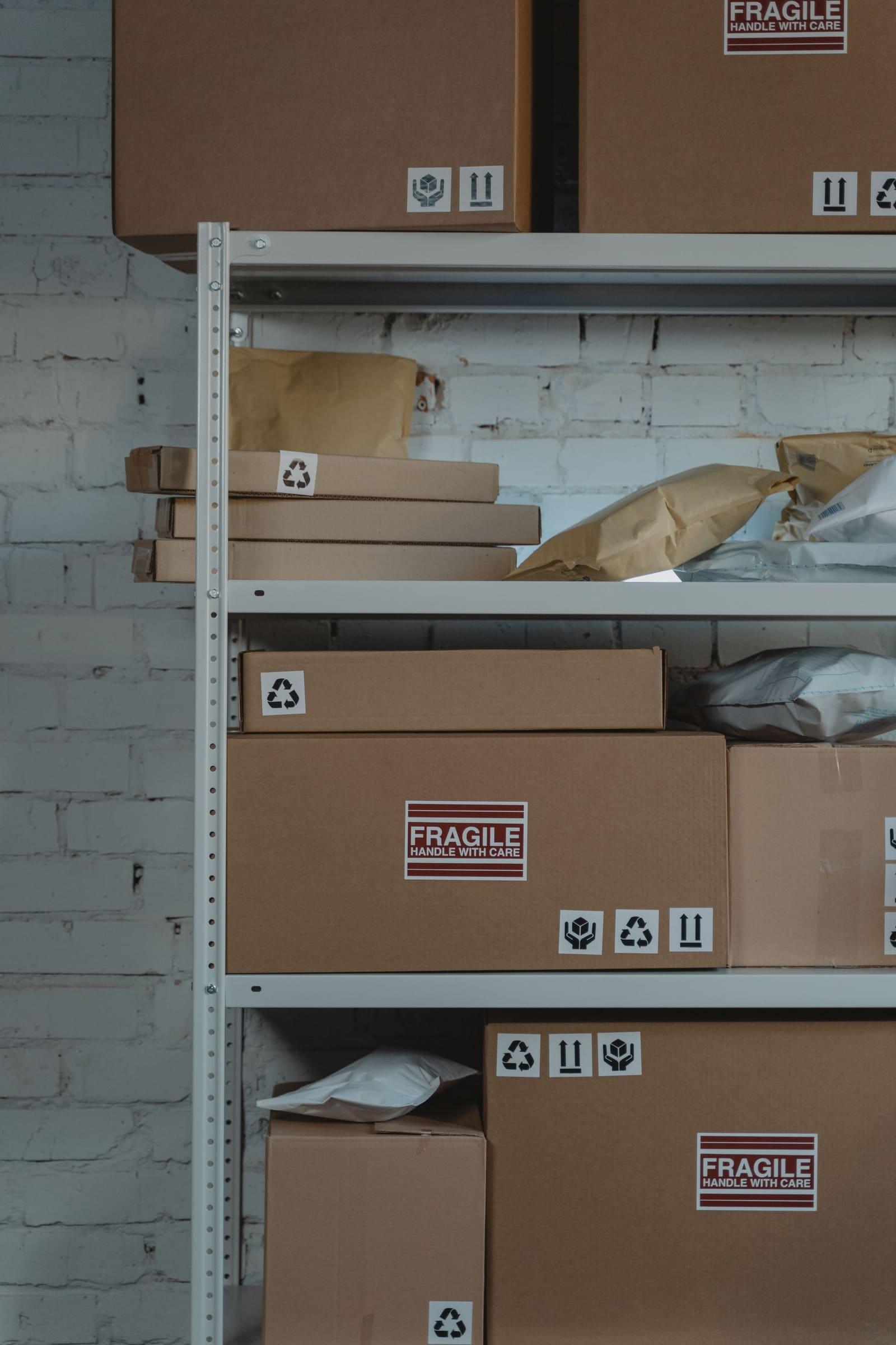 Shelving in a fulfilment operation holding cartons and packed parcels ready for picking.